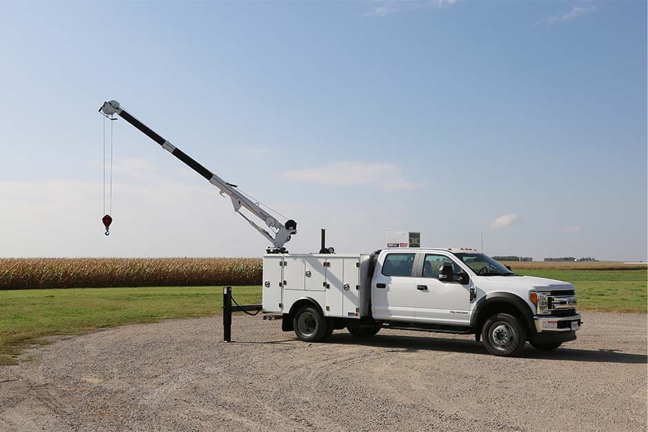 A white TMAX 30K facing to the right with a crane extended overhead