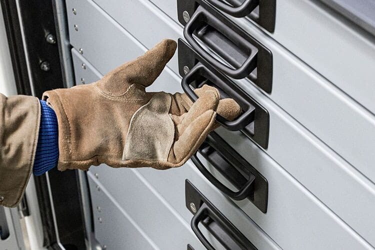 Person's hand reaching out to open Stellar's bale-style pull handles.