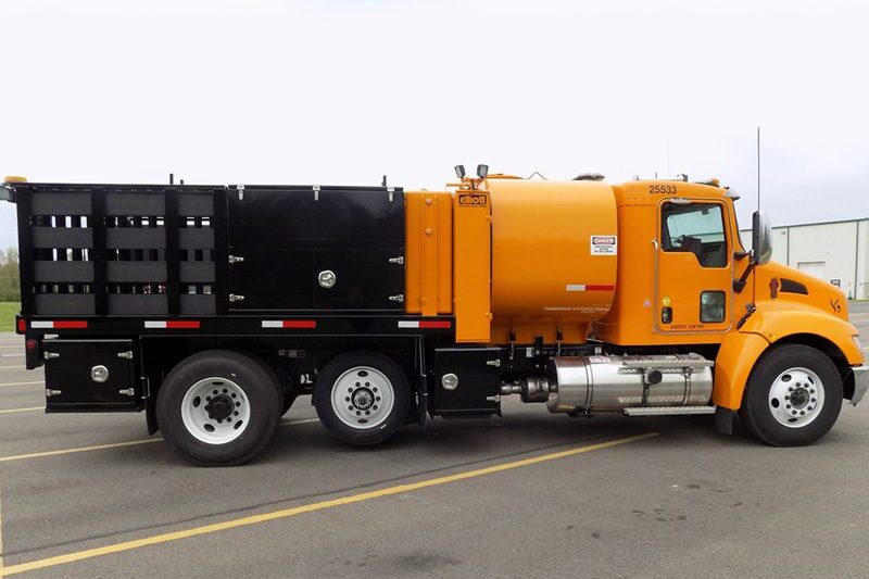 Orange specialty truck passenger side view