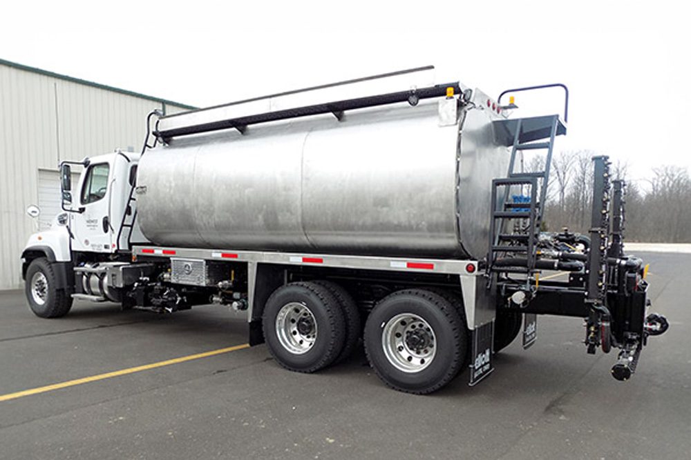 Silver water truck rear driver view