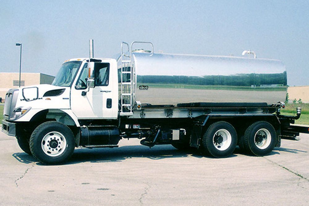 silver water truck driver side view